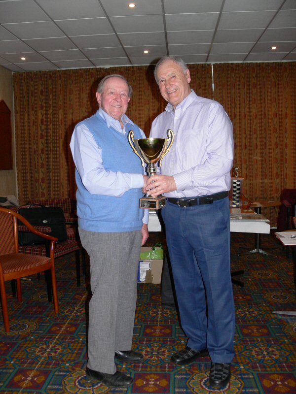 Dennis Wilkinson (Elite A) receives the Knock Out Cup Trophy.
