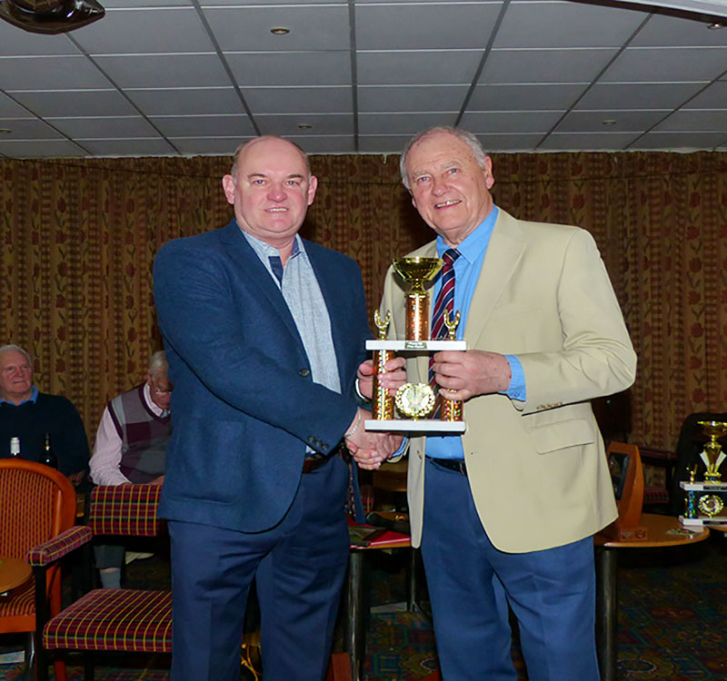 Nigel Holmes collects the Division 1 Merit Trophy from Chairman John Hilton