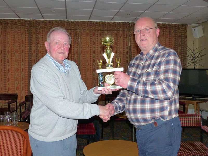 Hoole Village Hall's John Leek receives the Division 2 Merit Trophy from Dennis Wilkinson