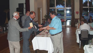 Malcolm Wharne receiving a prize